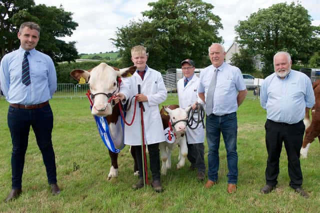 The Native Breed Reserve Champion of Newry Show 2023 went to a Hereford, Cornriggs Vanity 2nd from the Lisnaree Herd of the Murdock family. James McAvoy (l) and Alan Jones (r) with Judge Martin Kirk (c) offer their congratulations. Picture: Bo Davidson
