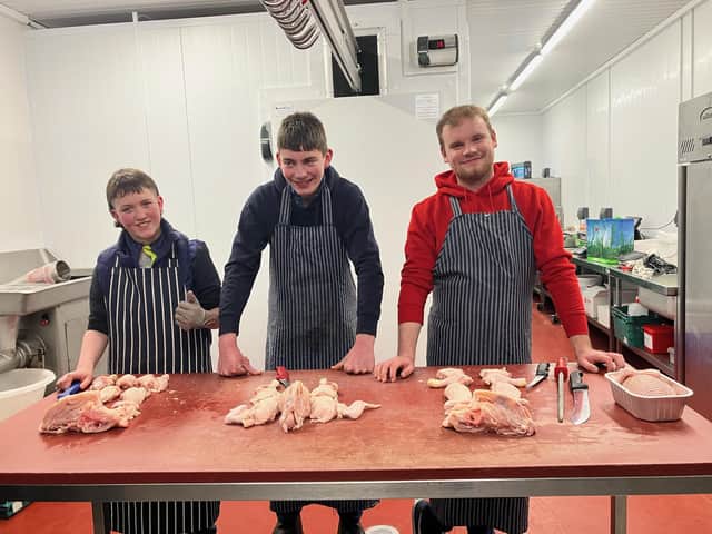 Riley Hoy, Thomas Wilson and Jack Stewart stuffing chickens