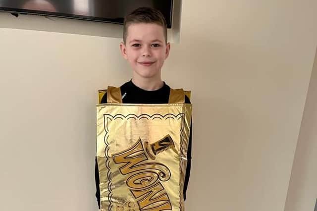 Seven year old John-Teddy Foster has dressed up as the most sought-after ticket in history - the Golden Ticket to enter the one and only Willy Wonka's factory.