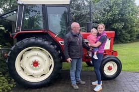 William McCracken with daughter Claire Walls and granddaughter Mollie Walls prepare to discuss the forthcoming Mollie's Charity Tractor Run. (Image supplied by William McCracken)