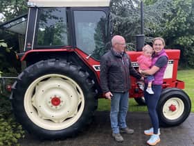 William McCracken with daughter Claire Walls and granddaughter Mollie Walls prepare to discuss the forthcoming Mollie's Charity Tractor Run. (Image supplied by William McCracken)
