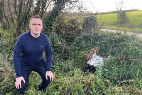 North Down MLA Stephen Dunne beside a dead goat that was dumped on the Ballymoney Road in Craigantlet.