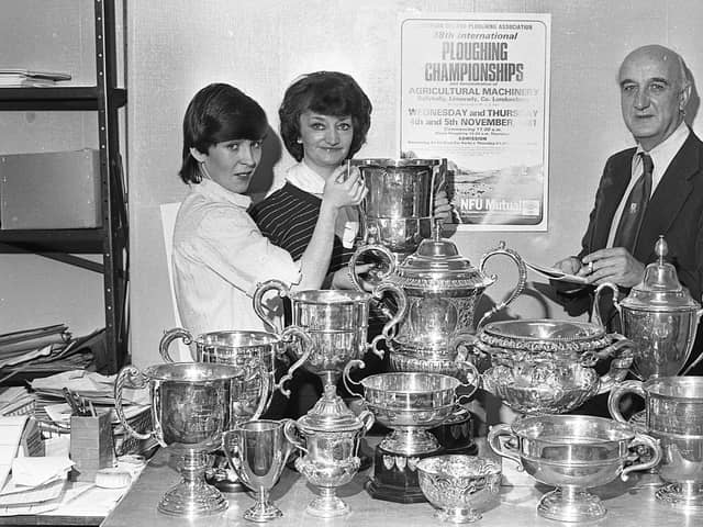 Pictured at the end of October 1981 is Frank Espley, secretary of the Northern Ireland Ploughing Association, sorting out the valuable array of trophies which were to go to the successful competitors of the international ploughing match which was to be held at Ballykelly at the start of November 1981. Assisting him are Mrs Mary Campbell and Mrs Rosheen Adair, who had been busy helping Frank finalise the arrangements for Northern Ireland’s biggest farming event of the year. Picture: News Letter archives/Darryl Armitage