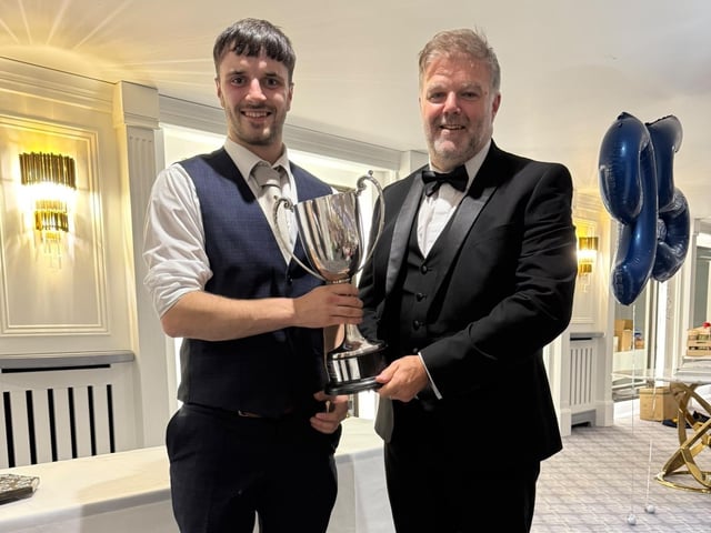 Samuel Aitcheson receiving the award for best new member.