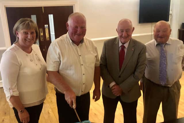 William Gill, European Vintage Ploughing Champion cuts a cake to mark his achievement on a night organised by Listooder Ploughing Society. Pictured along with William are his wife Fiona, Listooder President, Dai Kennedy and Listooder Chairman, Martin Gill.