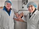 With some of the 400 ton of langoustines that are processed at Sea Source each year are (right) Sea Source chair, Brian Chambers and Presbyterian Moderator, Dr John Kirkpatrick, who visited the Harbour Estate at Kilkeel last week.