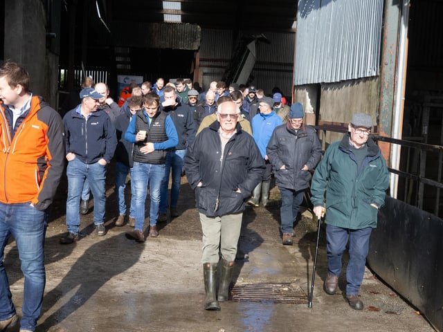 Visitors view one of the new polytunnels under construction at Workman Farms during the UGS visit