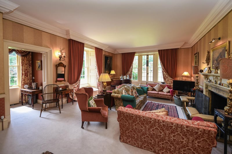 Queen Anne house with three reception rooms, nine bedrooms, nine bathrooms and woodland gardens.