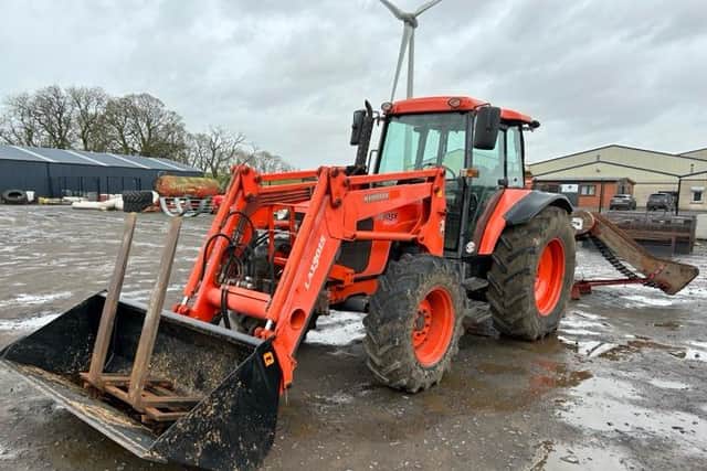 A Kubota M1055 Agricultural tractor and loader 2004.