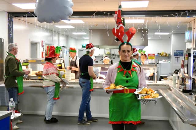 Norbrook team member Dearbhail McCullough serves hot meals at one of the company’s senior citizens Christmas dinners in Newry. Picture: Submitted