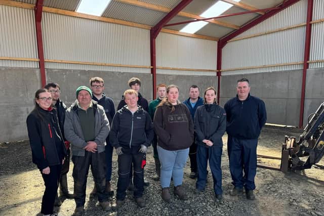 Standing in the new machinery shed that will deliver enhanced agri-educational opportunities for students attending Castle Tower School in Ballymena. Featured are the 2026 cohort of Castle Tower students who had an input into the development of the shed with their teacher Ciaran McCaughan (right) who was joined by teaching teaching assistants Shireen Davidson (second right) and Norman Manson (second left). Also featured is Moore Concrete's Maeve Birt (left). The new building predominantly features Moore Concrete wall panels.