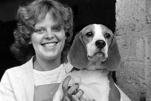 Veronica McConnell from Antrim is pictured with her Beagle pup at the Large White pig show and sale at Cookstown in August 1982, where her father-in-law Mr Robert McConnell, Ballymena Road, Doagh, exhibited the supreme champion male and reserve female. Picture: Farming Life/News Letter archives