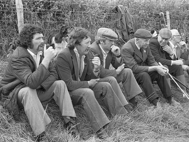Keeping an eye on the sheepdog trials at Cairncastle near Larne in 1981. Brilliant handling of his collies, Shane and Meg, resulted in Co Antrim farmer, Jim Brady of Ballyboley, collecting an armful of trophies at annual trials organised by the Cairncastle Sheepdog Society. Picture: Farming Life/News Letter archives