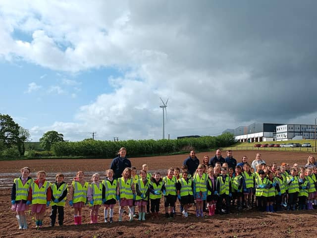 Primary 3 pupils and staff from Hardy Memorial Primary School pictured with Gilfresh Produce staff members during their recent visit to the company. The pupils planted some pumpkins and got a tour of the facilities at Gilfresh.