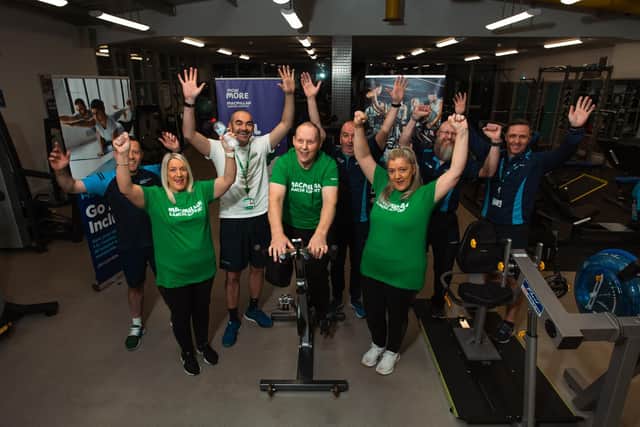 Norman Todd pictured during his triathlon in the Derg Valley Leisure Centre with front, Michelle McDougall, Siobhan Burns, and back, with DC&SDC Council Team, Robert Snodgrass, Fitness Instructor, Sean Harkin, Move More Coordinator, Vincent McCarron, Referral Program Consultant, Nik Monteith, Fitness Instructor, and Anthony McGonagle, Participation Retention Officer.  