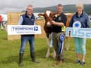 Kenny Coulter, from Thompson's, with Alan Paul, from Maghera, who qualified at Limavady Show with a cow from his Slatabogie Herd, and Kate Mark, NISA chair. Picture: Cliff Donaldson