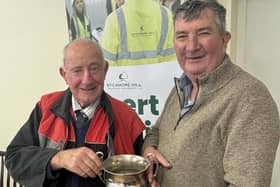 Society president Dai Kennedy is presented his trophy for Most Senior Competitor by host Mr James Baird at Listooder Ploughing match