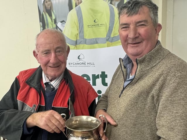 Society president Dai Kennedy is presented his trophy for Most Senior Competitor by host Mr James Baird at Listooder Ploughing match