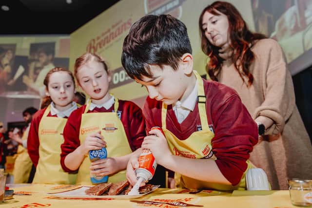 Brennan's Bread Dough It Yourself: St Anthony’s Primary School pupils Sophie McKeown, Emma Neville, Martin Maybin, Joseph Morrow and Francis McAllister. Pictured with event MC Denise Watson, Chef Brian Timon, and Ivan Hammond of Brennans Bread