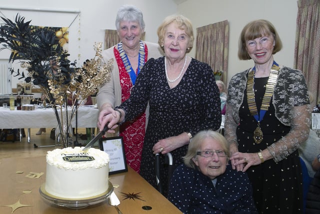 PIECE OF CAKE. Pictured cutting a cake to mark the 75th Anniversary of Armoy WI at Armoy Presbyterian Church Hall are longest serving member, Margaret Brown along with, Honoury Member, Florrie Spence, Chairman of The Federation of WI N.Ireland, Margaret Broome and current Armoy WI President, Margaret Gillan.