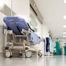 Blurred figures of people with medical uniforms in hospital corridor