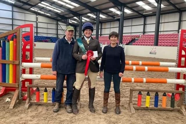 Emma Bell of Ard Lú Riding Club being presented with her sash, rosette and training bursary prize from AIRC Chairperson Tony Ennis and Judge Susanne Macken. (Pic: Ard Lú Riding Club)