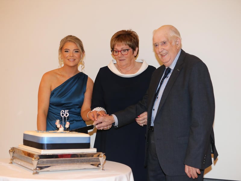 Cutting the cake, Zoe McIlroy (secretary), Rosemary McAllister (president) and James Brown (first club leader) at the recent Kells and Connor anniversary dinner. Picture: Steven McAuley