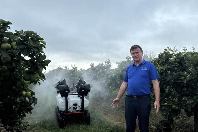 Kieran Lavelle, CAFRE Senior Adviser, observing a water dispersion from the remote-controlled ground sprayer at the recent orchard demonstration.