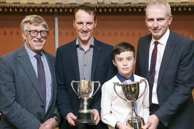 Mark and Oliver Thompson, (centre), winners of The Young Handler and Champion Crossbread of The Show receiving their prizes from Marcus Barton, Fermanagh Show and David Wright, Guest Speaker.