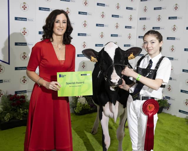 The first of the showmanship classes for Junior handlers at the 2022 Royal Ulster Winter Fair was won by Kate Jones from Gorey, Wexford who is pictured receiving her award from Debbie Reid, Danske Bank