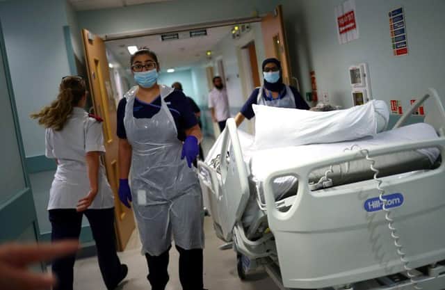 Medical staff transfer a patient along a corridor at the Royal Blackburn Teaching Hospital (Photo: HANNAH MCKAY/POOL/AFP via Getty Images)