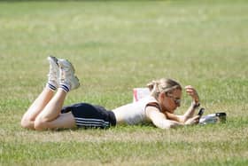 A person sunbathes in Richmond Green, south west London.