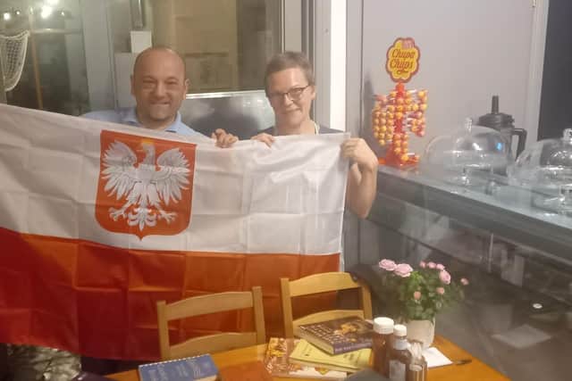 Marzena and Krzysztof with a flag. Pic: Portaferry WI