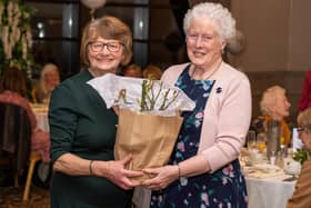 Margery Thompson receives a rose bush rom Rena Lindsay (vice-president) to mark 60 years of membership in Ballyrashane WI at the 80th anniversary dinner in the Royal Court Hotel. (Pic: Ballyrashane WI)