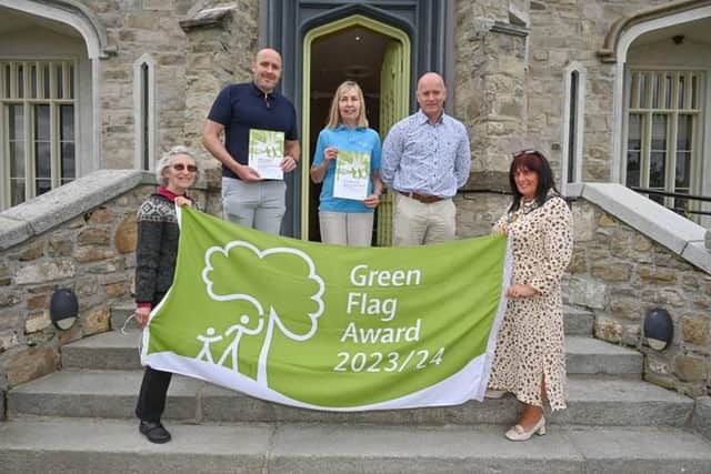 Professor Sue Christie OBE, Chair at Keep NI Beautiful (left) and Chairperson, Councillor Valerie Harte (right) help parks and tourism staff James Loughran, Patricia Sands and Jonathan Ellis celebrate six Green Flag Awards for Newry, Mourne and Down District Council