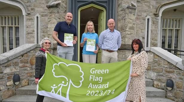 Professor Sue Christie OBE, Chair at Keep NI Beautiful (left) and Chairperson, Councillor Valerie Harte (right) help parks and tourism staff James Loughran, Patricia Sands and Jonathan Ellis celebrate six Green Flag Awards for Newry, Mourne and Down District Council