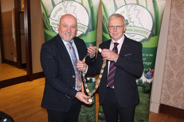 Outgoing Ulster Grassland Society president Colin Linton (left) hands over the chain of office to his successor, John Egerton.