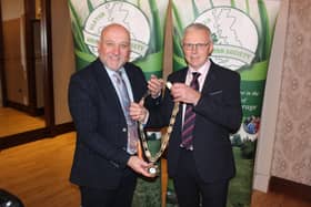 Outgoing Ulster Grassland Society president Colin Linton (left) hands over the chain of office to his successor, John Egerton.