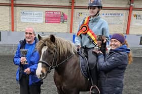 Caoimhe Hegarty presenting the Eugene Donnelly memorial cup to Lily Kelly on Peanut, winner of the 70cm Ecclesville Super League, with Lily's Granda, Anthony, holding the R D Equestrian Cup for the 60cm Super League, also won by Lily. (Pic: Ecclesville)