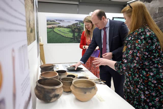 Communities Minister Gordon Lyons examines some of the HERoNI artifacts on exhibit at PRONI