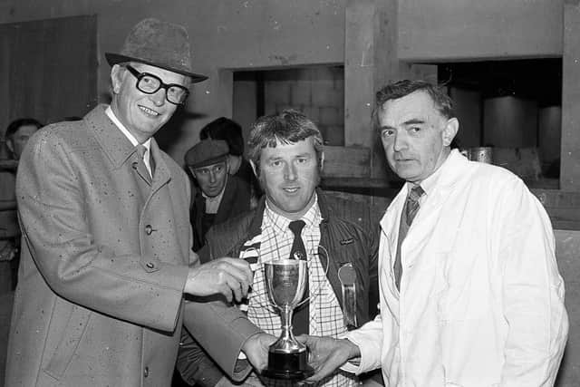 Pictured in September 1982 is Mr Campbell Rice, manager of the Ballynahinch and Saintfield branch of the Ulster Bank, presenting the championship trophy to Hugh Rankin, Newtownards, at the Suffolk sheep show and sale at Saintfield Mart. Also in the picture is Mr R Campbell Watson, Rasharkin, the judge. Picture: Farming Life/News Letter archives