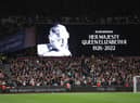 The LED board shows a photo Queen Elizabeth II as players of West Ham United and FCSB observe a minutes silence after it was announced that Queen Elizabeth II has passed away during the UEFA Europa Conference League group B match between West Ham United and FCSB at London Stadium on September 08, 2022 in London, England. (Photo by Richard Heathcote/Getty Images)