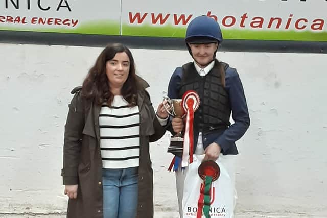 Overall individual winner, Charley Hanna, getting presented the Walker Perpetual Cup by Sonia Walker in memory of Sonia's pony Robbie. (Pic: Mossvale)
