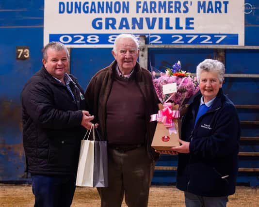 George McWhirter, chairman, and Cathy O’Hara, secretary, NI Aberdeen Angus Club, present a token to appreciation to George Wylie, Dungannon Farmers’ Mart. Picture: David Porter, Mullagh Photography