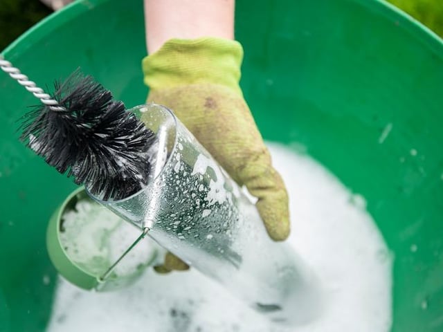 Cleaning a bird feeder to help prevent disease transmition