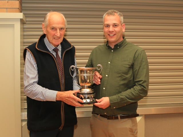 Sean Burns pictured with chairman Shane Mcdonald receiving the Bruces Hill Cattle company trophy for the overall champion animal at the club May sale for LONGBEACH ROCKY