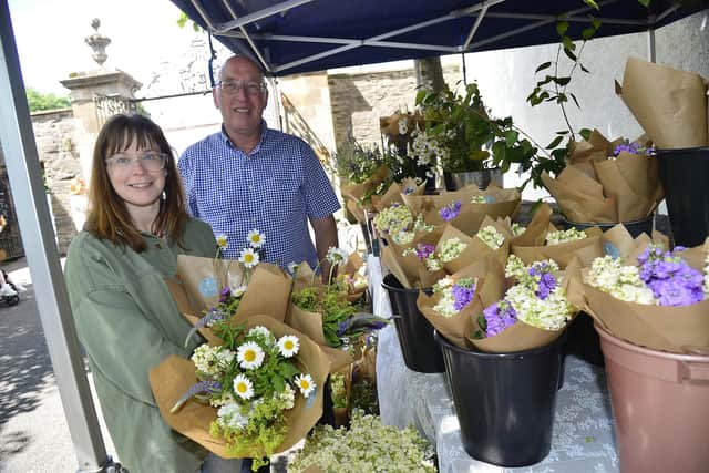 Marketgoers flocked to Royal Hillsborough on Saturday to attend Lisburn & Castlereagh City Council’s Royal Hillsborough Farmers Market on The Dark Walk at Hillsborough Fort. Pictured at the market are, left to right, Charlene McKinstry, Gracehill Flower Farm and Councillor John Laverty BEM, Chairman of the council’s Regeneration & Growth Committee. Picture: LCCC