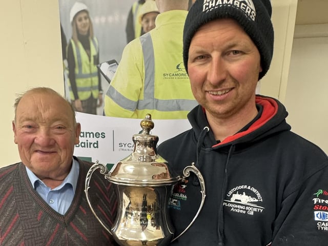 Chairman Martin Gill presents Andrew Gill his trophy as Champion of the Field at Listooder Ploughing Match