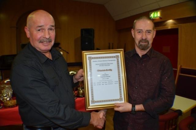 Jeff McMaw (r) collects a Merit Award from Carrick Social secretary George Robinson. Pic: Homer
