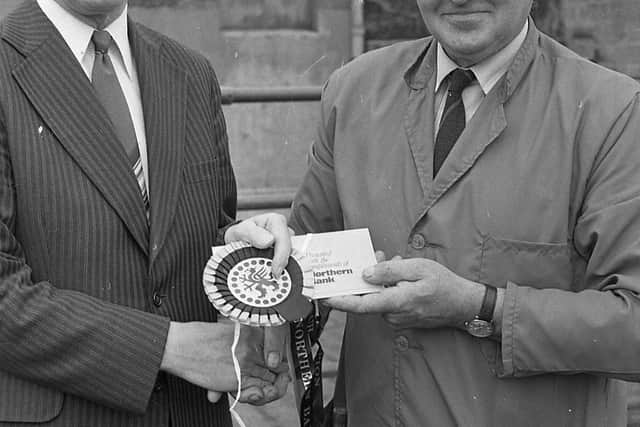 Mr J Hill, manager of the Ballymena branch of the Northern Bank, presenting the championship rosette to James Armstrong from Broughshane, Co Antrim, at the Blackface sheep show and sale at Ballymena in October 1982. Picture: Farming Life/News Letter archives
